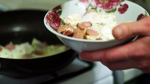 Man puts the eggs in a bowl Video stock 70631551
