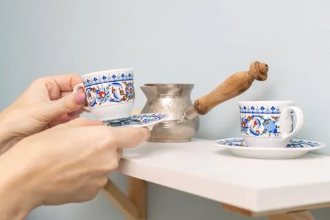 A man puts an empty cup on a shelf. Stock Photos