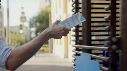 Man puts empty packaging of drink into large trash bin Stock Footage 144488843