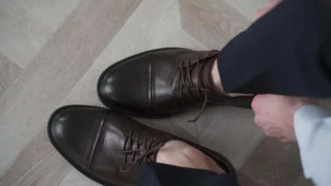 A man puts on expensive shoes and gets ready for a business meeting Stock Footage 329092281