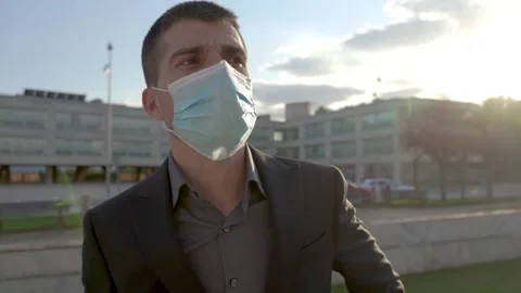 Man puts on a face mask. Light blue face mask during a coronavirus pandemic Stock-Footage 141916188