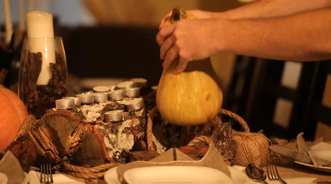 Man puts festive pumpkin Stock Footage 57556120