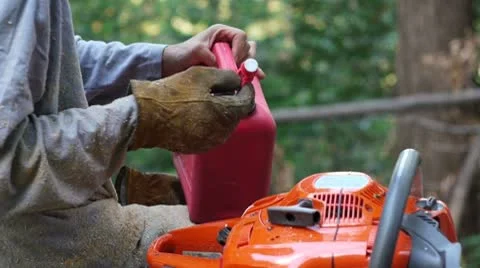 Man puts fuel in chainsaw Stock Footage 8959867
