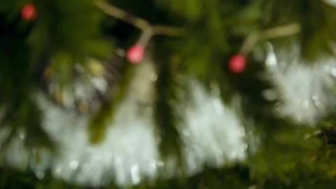 A-man-puts-a-gift-under-the-Christmas-tree 動画素材 137838765