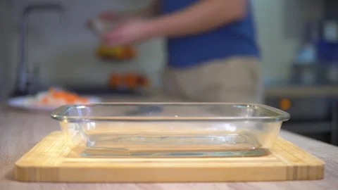 A man puts a glass dish fish. Cooking fish Stock Footage 101552278