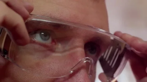 The man puts on goggles to protect his eyes from injury. Stock Footage 169461979