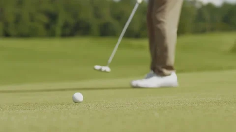 Man Puts Golf Ball Into Hole Stock Footage 160129312