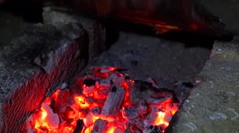 Man puts grill basket with fish on brazier full of live coals. 库存影片 54237676