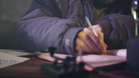 Man puts hand on diary to continue writing personal thoughts Stock Footage 228780228