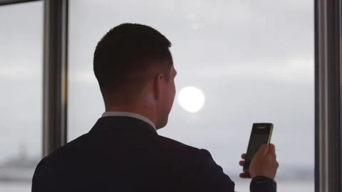 Man puts up hand with mobile phone for message checking Stock Footage 244786512