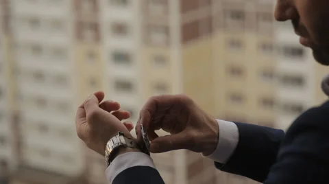 A man puts into the hands of the clock Stock Footage 61215034