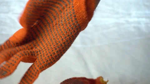 Man puts on hands red thin gloves to work in the garden Stock Footage 139462208