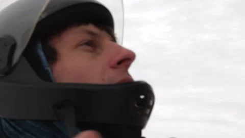 A man puts on a helmet and corrects it, prepares for a parachute jump Stock Footage 195557933