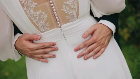 A man puts his arms around his woman's waist. Shooting from the back Stock Footage 328514112