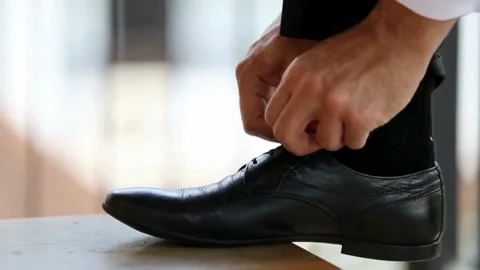 Man puts on his formal Leather black classic shoes. The groom or businessma.. Stock Footage 265943841