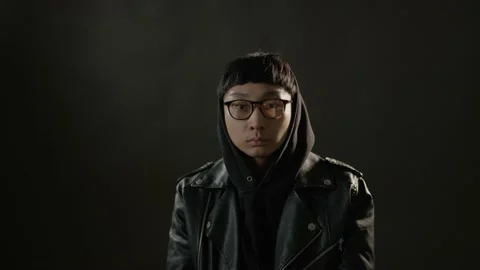 A man puts on his glasses and takes on a hood. Shot from the film. Stock Footage 195182067