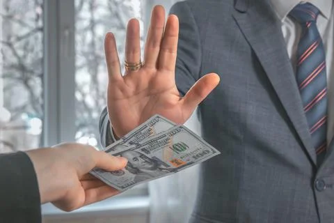Man puts his hand forward and refuses to take dollars for a bribe. Corruption Stock Photos