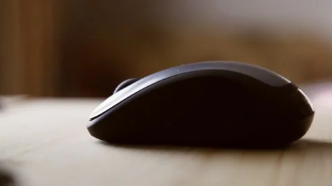 The man puts his hand on the mouse and making stupid Stock Footage 135044161