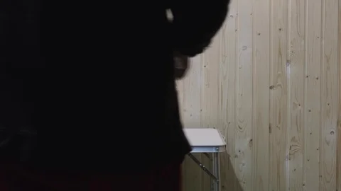 The man puts his smartphone on the table and sits down Stock Footage 119547772