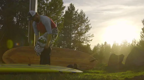 Man puts his wetsuit on Stock Footage 62840523