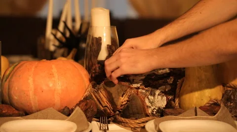 Man puts the holiday candles on the table Stock Footage 57559545