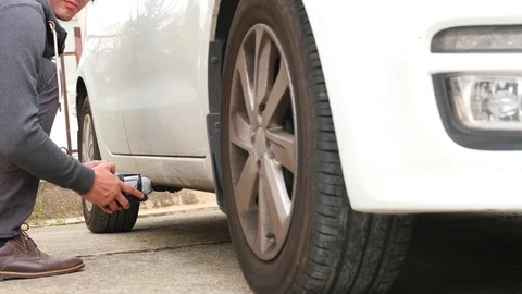 A man puts a homemade explosive device under the car. Preparation of terrorist Stock Footage