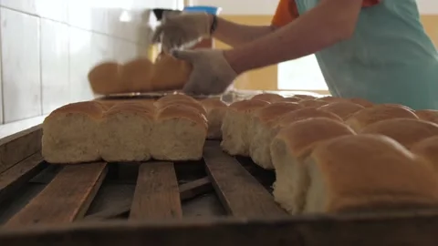 Man puts hot fresh bread Stock Footage 133197330