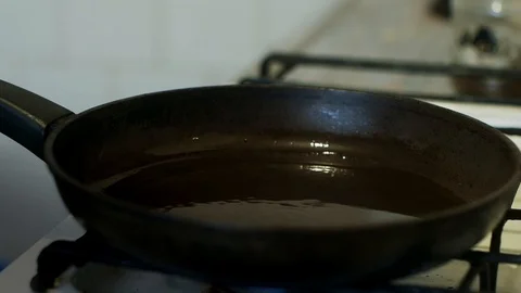  A man puts it in a pan and fries meat in tomato sauce in the home kitchen. Stock-Footage 127626461