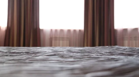 The man puts the jacket and shirt on the bed Stock Footage 67350012