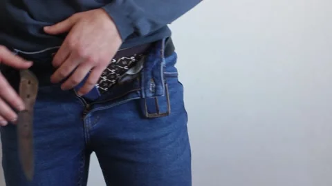 A man puts on jeans. Video stock 130638916