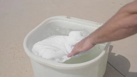 Man puts laundry in non automatic washing machine Stock-Footage 301420554
