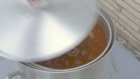 Man Puts a Lid on Large Metal Pot of Boiling Crawfish Stock Footage 75004751