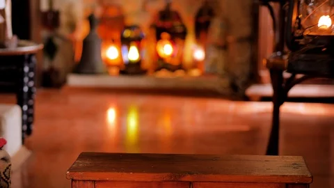A man puts a lighted  kerosene lamp on a table Stock Footage 124679897