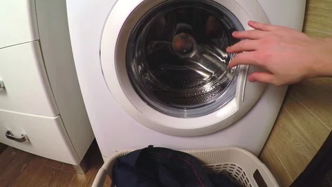 The man puts linen in the washing machine. POV look Stock Footage 82618143