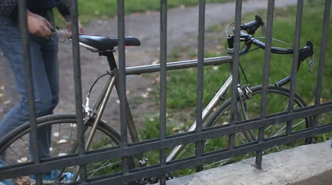 Man puts the lock on the bike Stock Footage 54359026