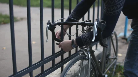 Man puts the lock on the bike Stock Footage 54409581
