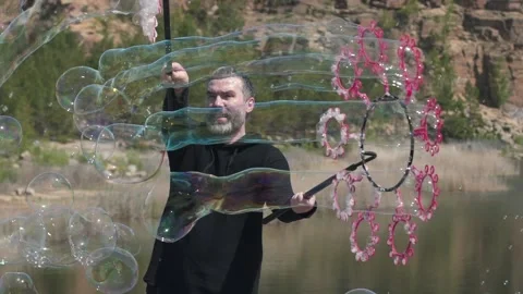 Man puts a lot of soap bubbles Video stock 131492875