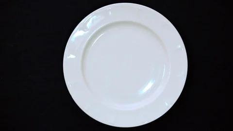 Man puts macaroons or macarons in a pile of almond cookies 4k. Male hand puts ma Stock Footage 128768165