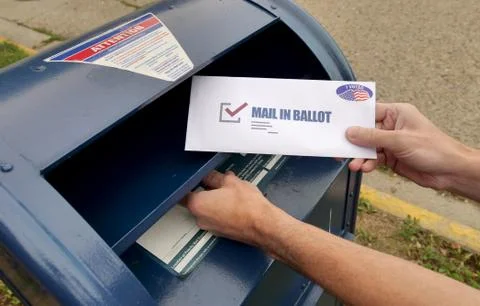 Man Puts Mail In Ballot in Mail Box Stock Photos