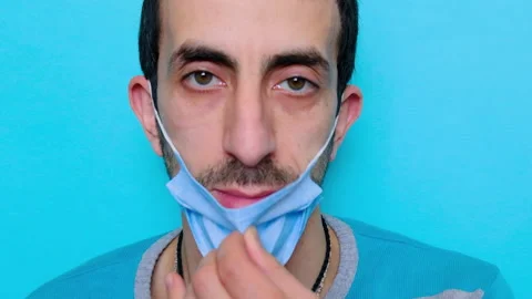 The man puts on a mask on his face. Selective focus. Stock Footage 152563377