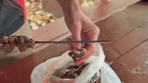 Man puts the meat on a skewer Stock Footage 69162992