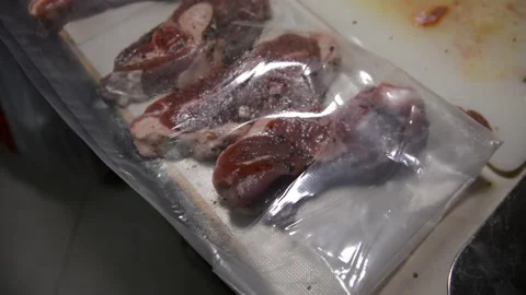 Man puts meat in a vacuum sealer film Video stock 130371904