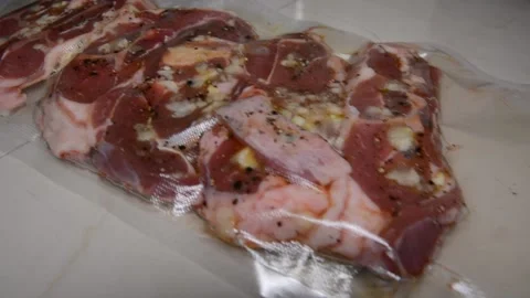 Man puts meat in a vacuum sealer film Video stock 130371924
