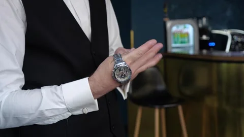 The man puts on a mechanical watch on his wrist. Stock Footage 268190212