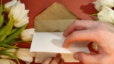 A man puts a message on a piece of paper I love you in an envelope Stock-Footage 148338643