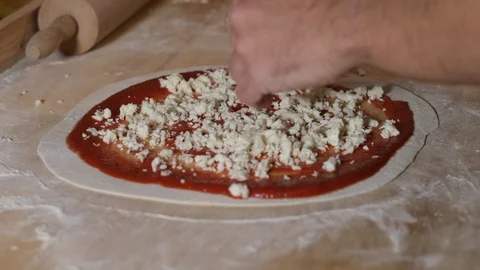 Man puts mozzarella on the pizza. Man does homemade pizza Stock Footage 122139539