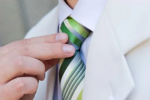 Man puts on a necktie Stock Photos