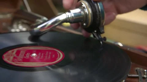 Man Puts a Needle on a Record Spinning on an Antique Gramophone. Stock Footage 271153767