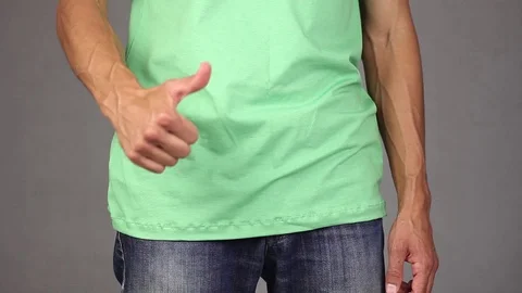 Man puts new condom in the front pocket of blue jeans, pats and gesture thumb up Video stock 94926996