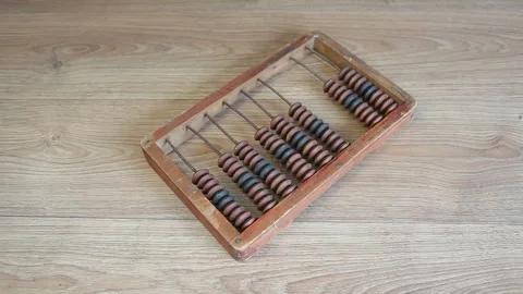 A man puts an old wooden abacus on the table Stock Footage 243104350